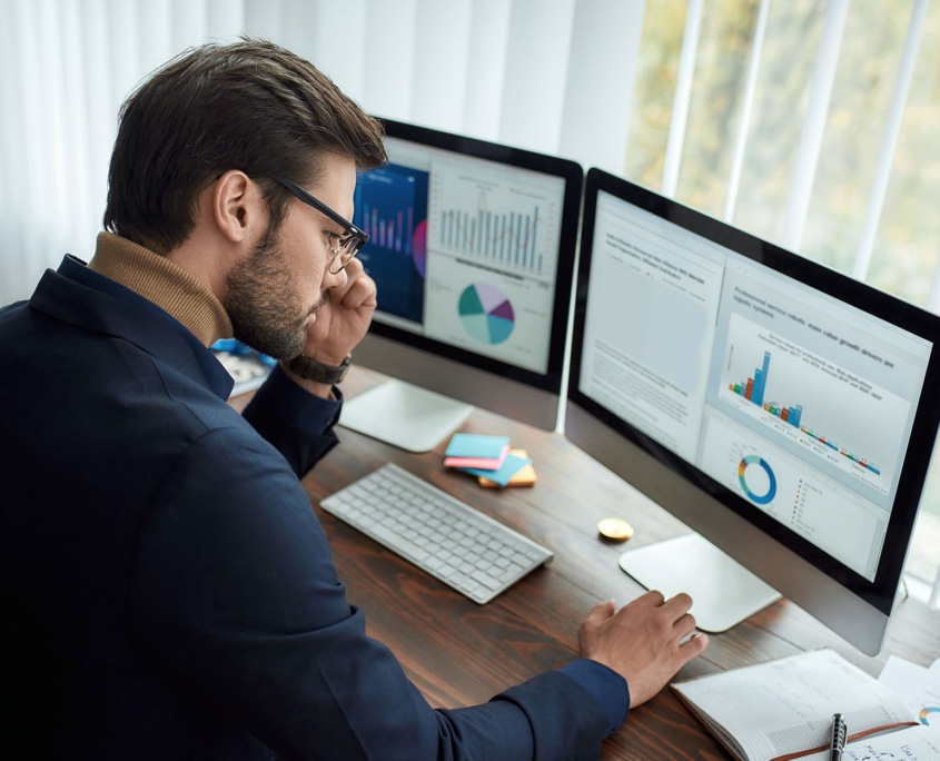 Worker looking at charts on computer