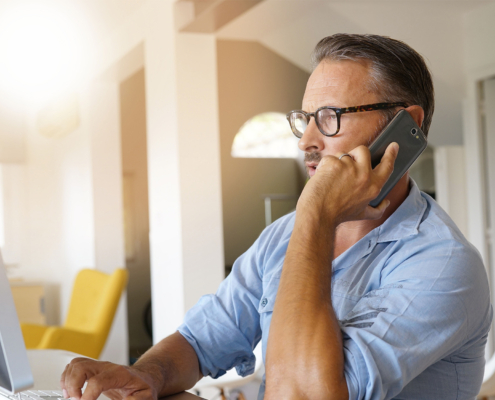 Home-office businessman talking on phone