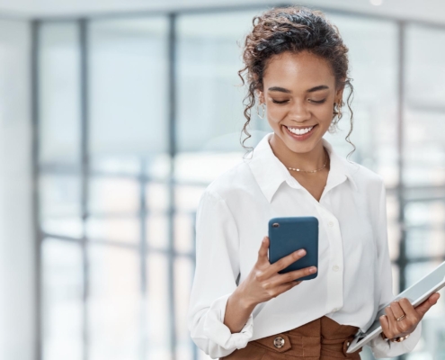 Business person walking through office on phone call