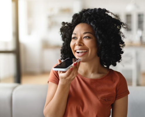 Front view of woman talking happily on smartphone