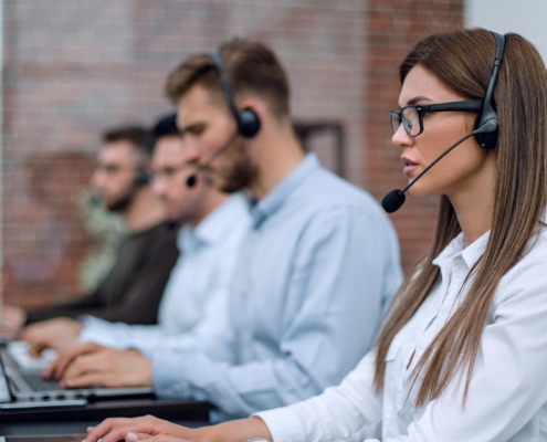 Group of wormers in call center with headsets