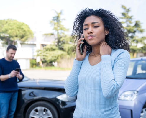 Person on phone with insurance after car accident